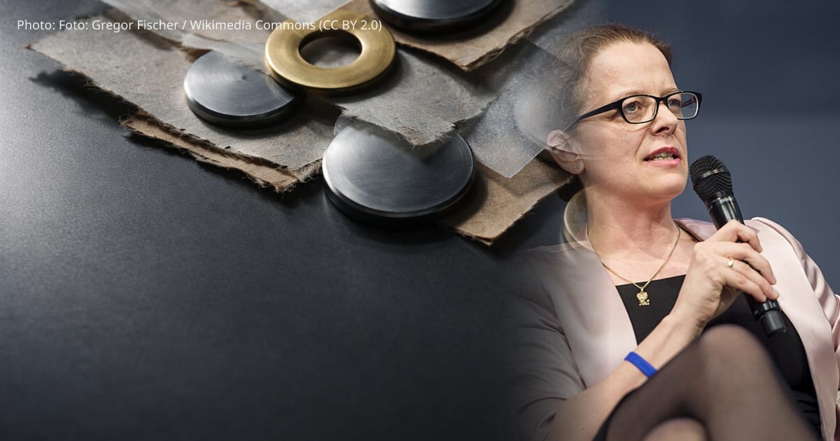 Isabel Schnabel β Close-up reflected composition of overlapping unbranded metal discs, brass washers and translucent vellum strips on a dark tabletop, arranged in the upper two-thirds with soft reflections below and moody directional lighting.