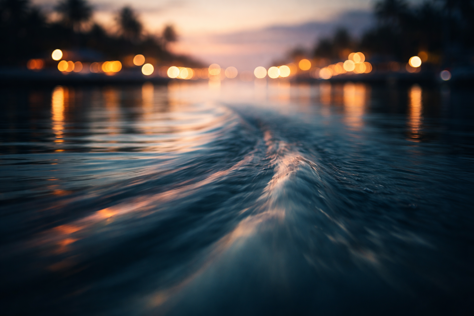 Long-exposure close shot of harbour water showing a smooth wake and streaked amber-teal reflections concentrated in the upper two-thirds of the frame, with a dark calm lower third left empty for headlines.